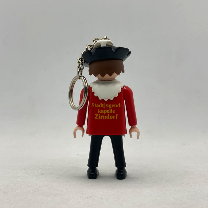 Llavero Playmobil Músico de Zirndorf por detrás, con la serigrafía dorada Stadtjugendkapelle Zirndorf y su cadena