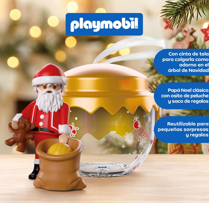 Figura de Papá Noel clásico del Playmobil 72224 con traje rojo, osito de peluche y saco de regalos con pelota junto a la bola dorada