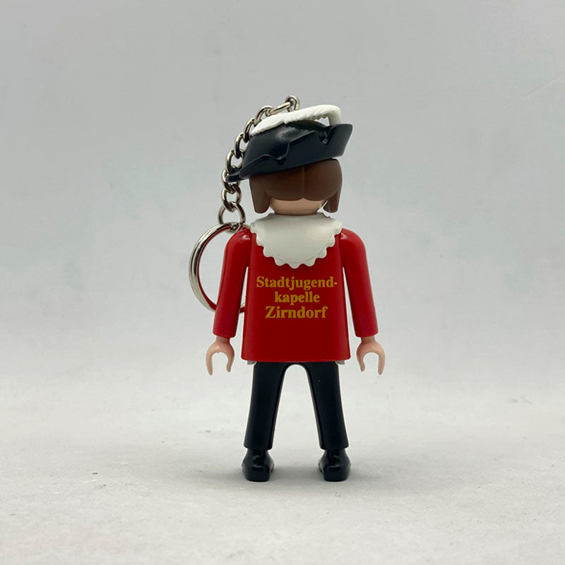 Llavero Playmobil Música de Zirndorf por detrás, con la serigrafía dorada Stadtjugendkapelle Zirndorf y su cadena