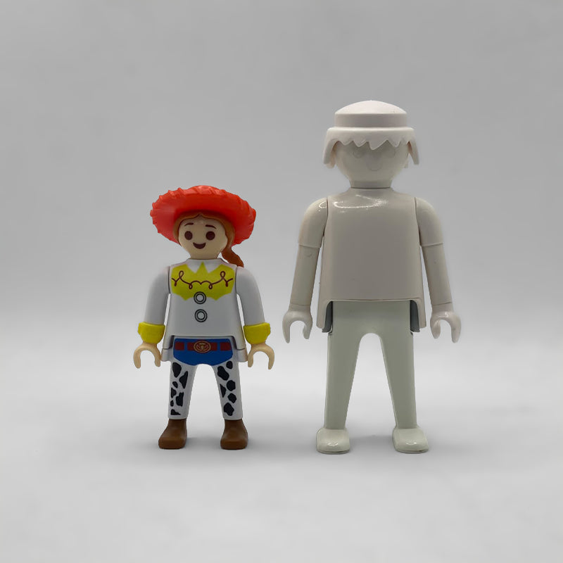 Comparativa de tamaño: minifigura Jessie FCO994 junto a una figura Playmobil estándar blanca, no incluida